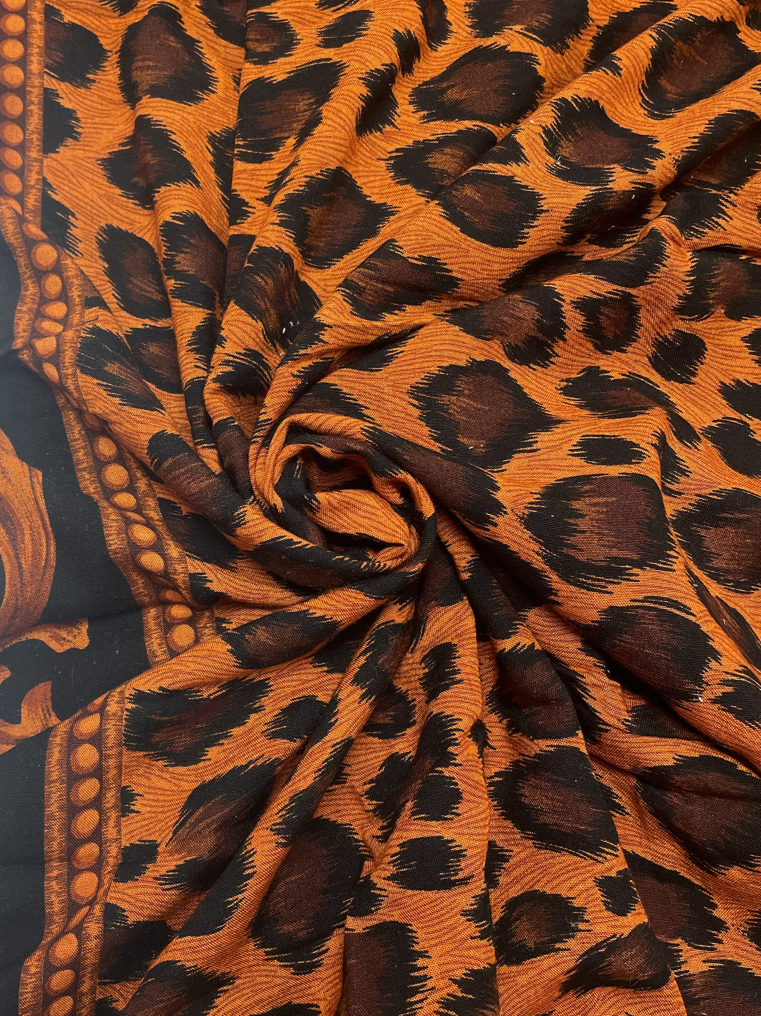 1 7/8 YD Rayon - Black and Orange Cheetah Print with a Filigree Border