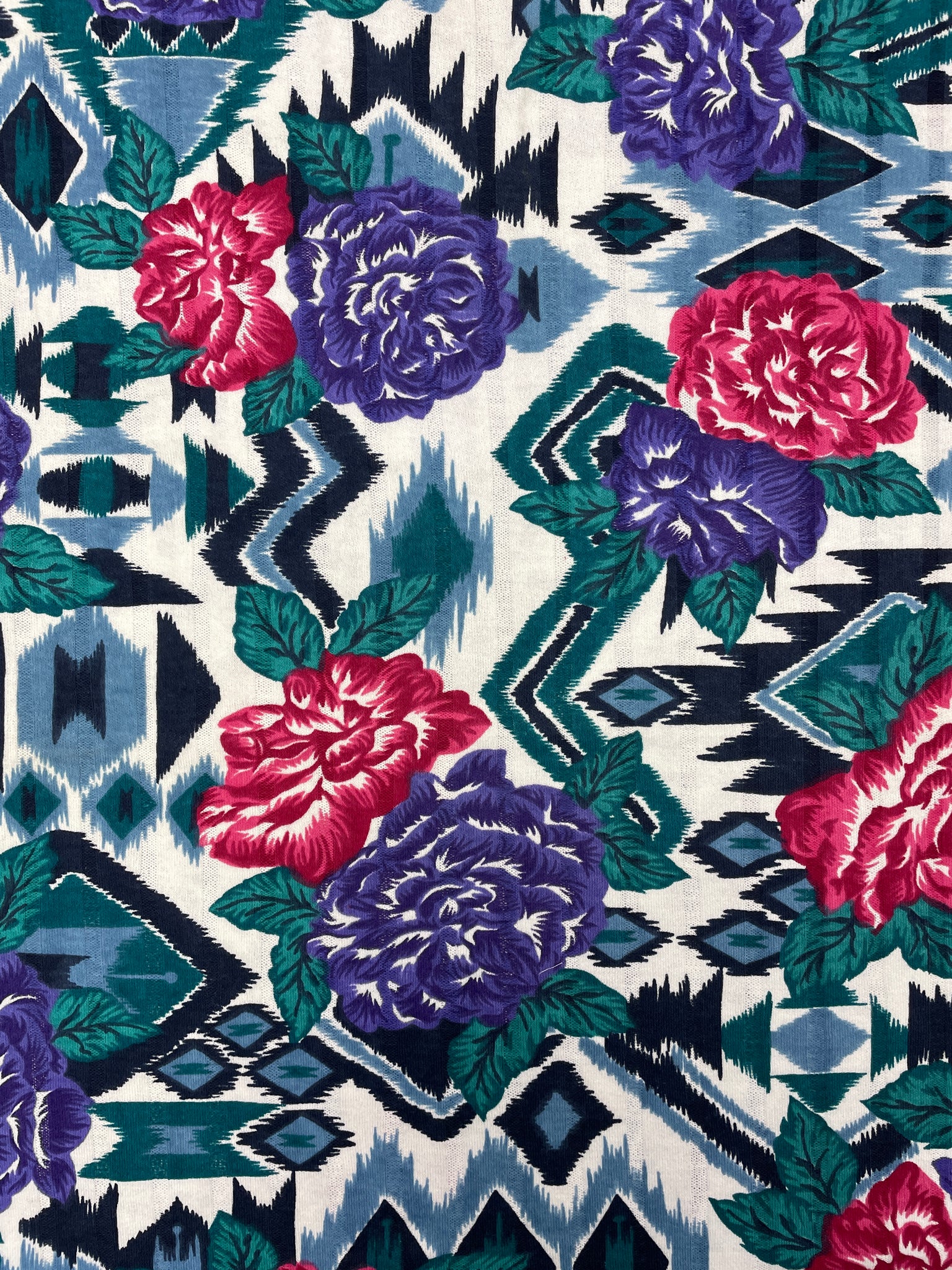 1 YD Poly/Cotton Knit with Self Stripe Vintage - Flowers in Red and Purple Over Southwestern Style Graphics in Green, Blue and Black