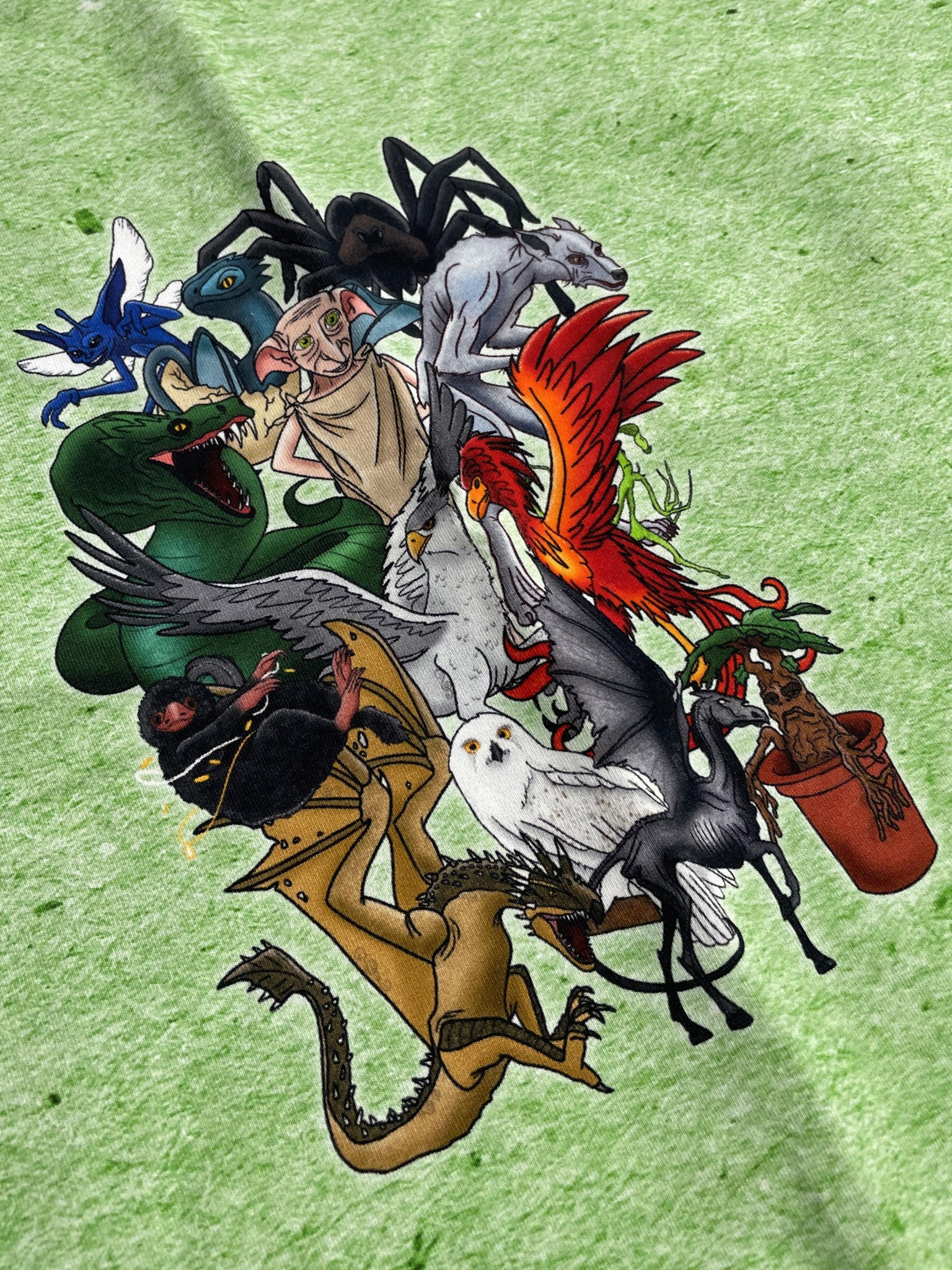 1 YD Cotton Stretch Knit Remnant - Creatures From "Harry Potter" on Heather Green